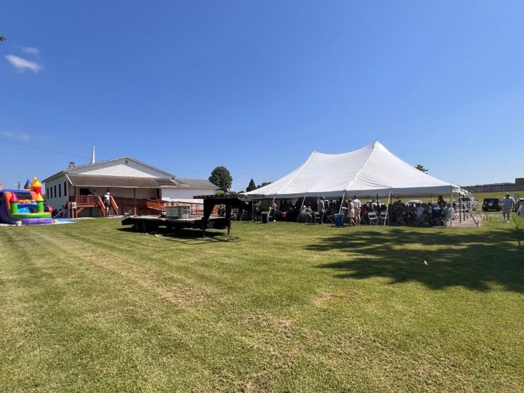 Community tent rentals in Indiana at Grace church showing church during baptism event.